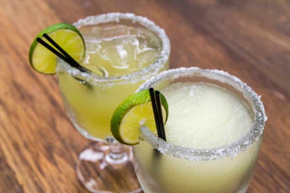 margaritas with lime wedges